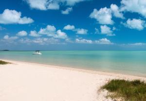 a boat in the water on a beach at Clevelander in Long Bay Hills