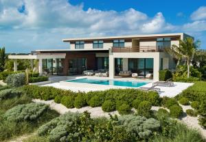 a house on the beach with a swimming pool at Clevelander in Long Bay Hills