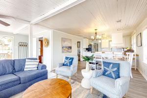 a living room with a blue couch and two chairs at Aloha Friday in Edisto Island