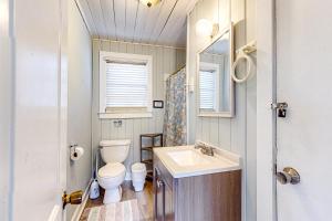 a small bathroom with a toilet and a sink at Aloha Friday in Edisto Island +14 photos