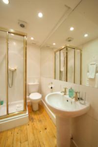 a bathroom with a sink and a shower and a toilet at The Ben Doran Guest House in Edinburgh
