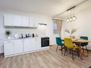 a kitchen and dining room with a table and chairs at SubCetate in Sighişoara