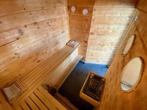 an overhead view of a wood paneled room in a tiny house at "Talludden" by the lake Årydssjön, in Furuby