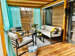 a screened in porch with a table and chairs at Iris Holiday Homes - Camping park Soline in Biograd na Moru