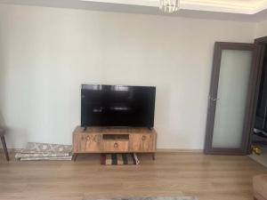 a living room with a flat screen tv on a wooden entertainment center at Apartment with nice view in Beylikduzu