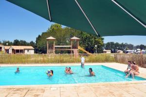 a group of people in a swimming pool at Le colvert in Orist +6 photos