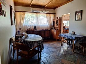 a living room with two tables and a kitchen at Emani Guest House in Mokopane
