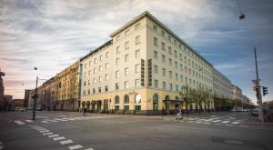 a large building on the corner of a street at Hotel Helka in Helsinki