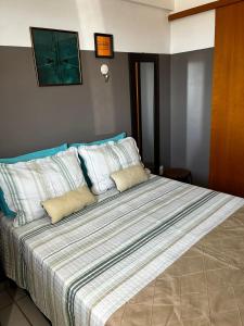 a bedroom with a large bed with white pillows at Apartamento Nova Betânia - West Flat Mossoró in Mossoró