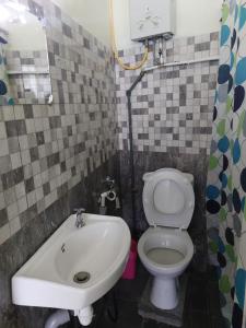 a small bathroom with a toilet and a sink at Rental Furnished Studio in Port Louis