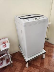 a white stove sitting on a cart in a kitchen at Rental Furnished Studio in Port Louis