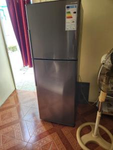 einem Kühlschrank aus Edelstahl in einer Küche mit einem Staubsauger in der Unterkunft Rental Furnished Studio in Port Louis