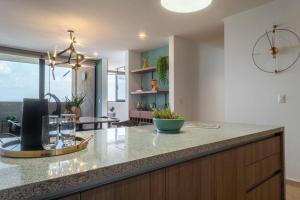 a kitchen with a counter with glasses on it at Nuevo Departamento en Zibatá Querétaro, 4 Personas in La Cañada +22 photos