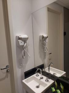 a bathroom with a sink and a mirror at Flat / Studio Allianz Parque in Sao Paulo