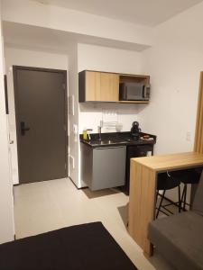 a small kitchen with a sink and a microwave at Flat / Studio Allianz Parque in Sao Paulo