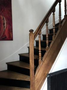 a set of stairs with a wooden stair case at Pavillon avec cour privée in Bagnolet
