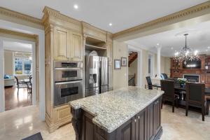 a kitchen with a kitchen island with a counter top at Luxury 4BR - Pool Table - 10 min to Yorkdale Mall in Toronto