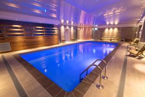 a large swimming pool in a hotel room at Ilsington Country House Hotel & Spa in Ilsington