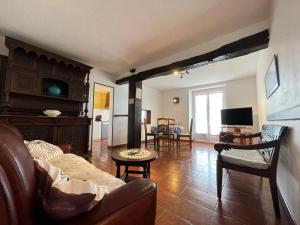 a living room with a couch and a table at Barrukia in Uhart-Cize