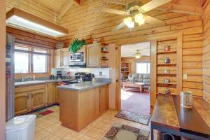 a kitchen with wooden cabinets and a ceiling fan at Prescott Vacation Rental with Deck and Mountain Views in Prescott