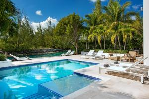 a swimming pool with chaise lounges and a resort at 18 Kelly Isle in Long Bay Hills