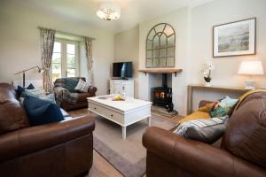 sala de estar con 2 sofás y chimenea en Overview Cottage en Belford