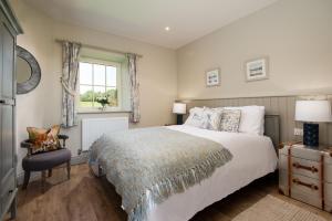 a bedroom with a large bed and a window at Overview Cottage in Belford