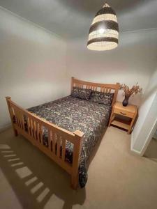 a bedroom with a bed and a pendant light at Wonderful House In Winchester in Wonston