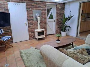 a living room with a brick wall and a stove at Wonderful House In Winchester in Wonston