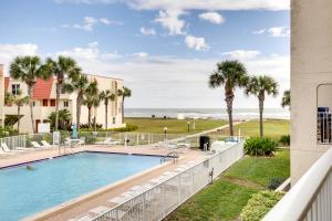 a view of the pool and beach from the balcony of a resort at St Augustine Oasis Community Pool and Private Patio in Saint Augustine