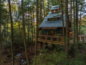 a tree house in the middle of the forest at Enchanted Evergreen in Coffeyville