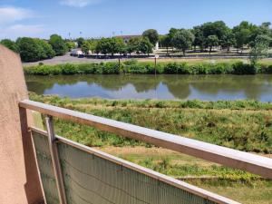 a view of a river from a balcony at Les rives de l'adour in Dax