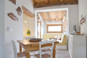 a kitchen and dining room with a table and a couch at Holiday Home Fisherman in Umag