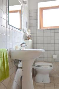 a bathroom with a white sink and a toilet at Holiday Home Fisherman in Umag