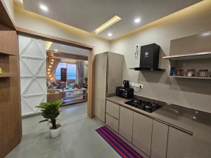 a kitchen with a sink and a counter top at Ivory sea castle in Kozhikode