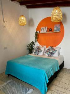 a bedroom with a bed with an orange headboard at Spring Hostel in Medellín