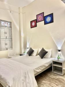 a bedroom with a bed with four pictures on the wall at Holy River Stays in Varanasi