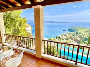 a balcony with a view of the water at Villa Tesoro Kalami with private pool by DadoVillas in Kalami