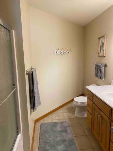 a bathroom with a toilet and a sink at Beautifully Furnished 5-Bedroom in Rochester
