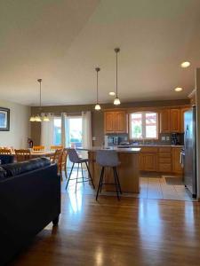 a kitchen and living room with a table and chairs at Beautifully Furnished 5-Bedroom in Rochester