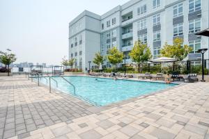 a swimming pool in front of a building at Oakland Studio w Gym Pool AC near Target SFO-701 in Oakland