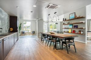 a kitchen and dining room with a wooden table and chairs at Oakland Studio w Gym Pool AC near Target SFO-701 in Oakland