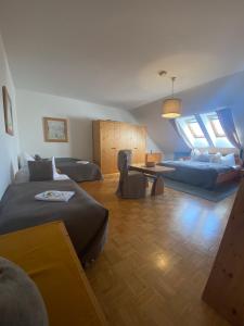 a living room with two beds and a couch at Pension Rucksackpeter in Hohenbrugg an der Raab