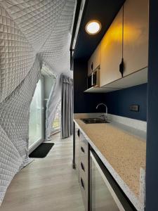 a kitchen with a sink and a counter top at NaturHotel in Cuenca