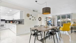a kitchen and dining room with a table and chairs at Tides Miami 2BR Condo on the beach in Hollywood