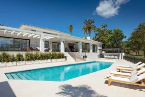 a villa with a swimming pool and a house at Villa Mercedes - Luxury 5-Bedroom Villa in Las Brisas, Marbella in Marbella