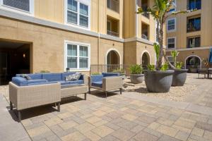 a patio with couches and chairs in front of a building at San Bruno 1BR w Pool Gym WD nr highways SFO-812 in San Bruno