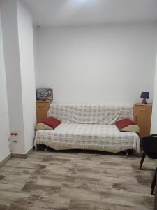 a couch sitting in a living room next to a wall at Apartament Karina in Baia Mare
