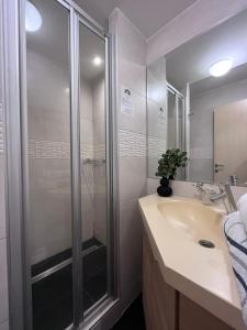 a bathroom with a glass shower and a sink at Apartment Dunja Konaci in Kopaonik