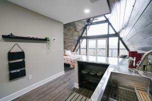 a kitchen with a counter and a large window at The Maverick: A-Frame w/ Hammock and Tree Top View in New Braunfels